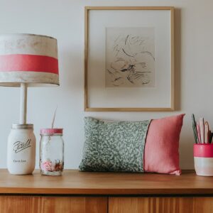 DIY bedroom decorated with fairy lights in a mason jar nightlight and a throw pillow made from fabric scraps.