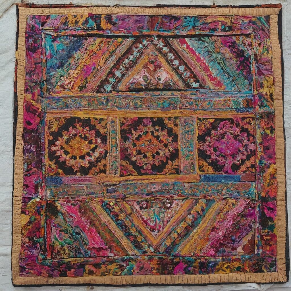 A close-up view of a colorful Indian embroidered tapestry.