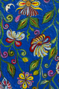 A close-up photo of a Kalamkari textile showcasing intricate hand-painted designs and vibrant natural dyes.