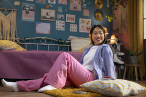 smiley girl sitting in a decorated room