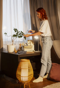 Teenage bedroom decorated in boho chic style with fairy lights, floor cushions, colorful rugs, throw pillows, and a tapestry wall hanging.