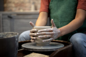 Hands doing pottery side view