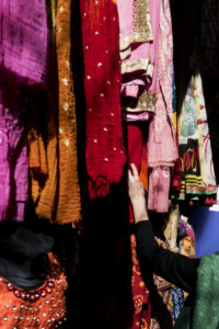 "Colorful Indian handloom fabrics displayed in a market"