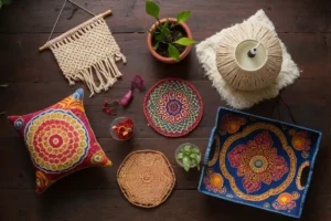 Colorful Indian-inspired home decor crafts by Tanutra: Cushion covers, terracotta planters, macramé wall hangings, rangoli coasters, sari silk lampshade, beaded door curtains, and Madhubani art tray.