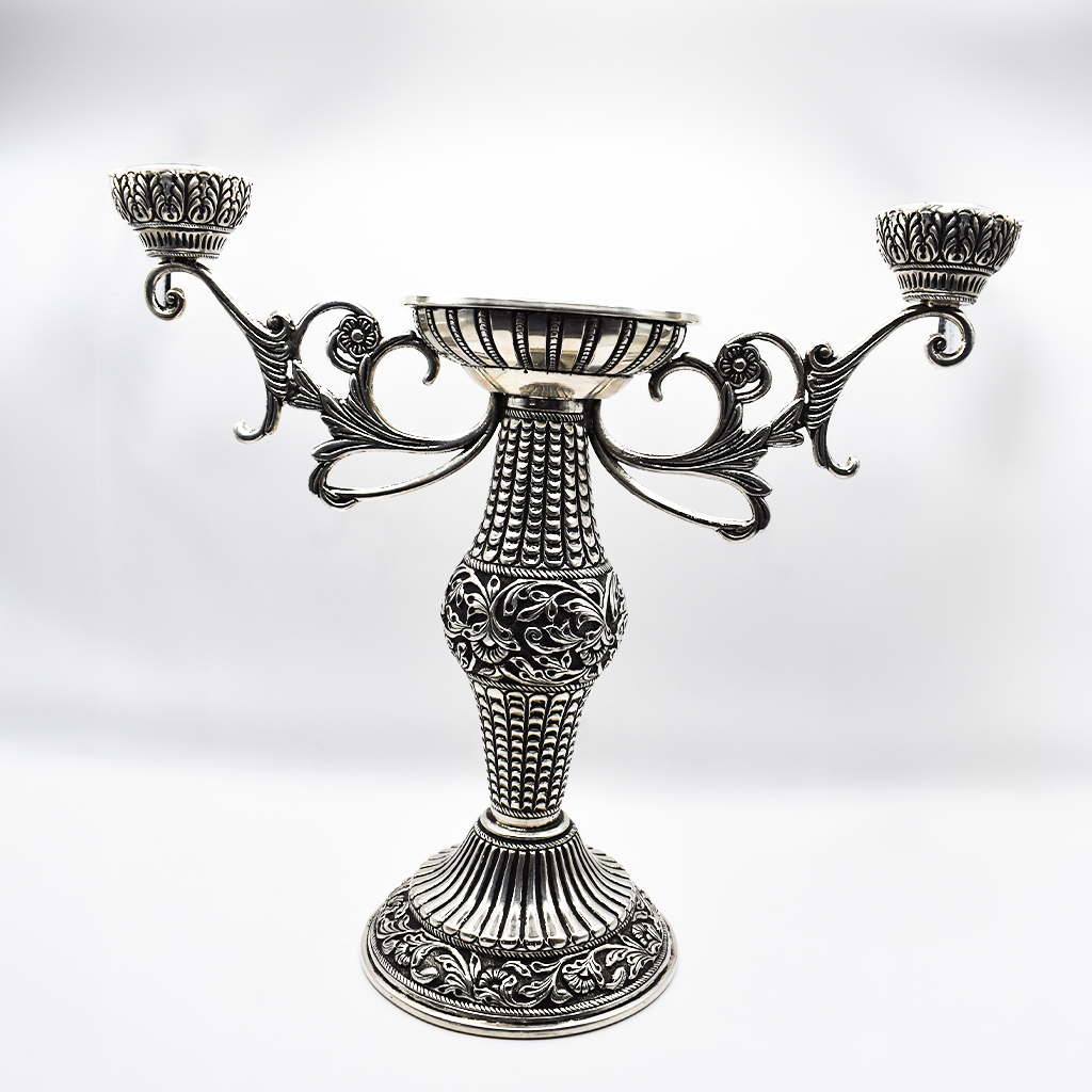 Silver Candle Holder elegantly placed on a coffee table, enhancing the living room ambiance.