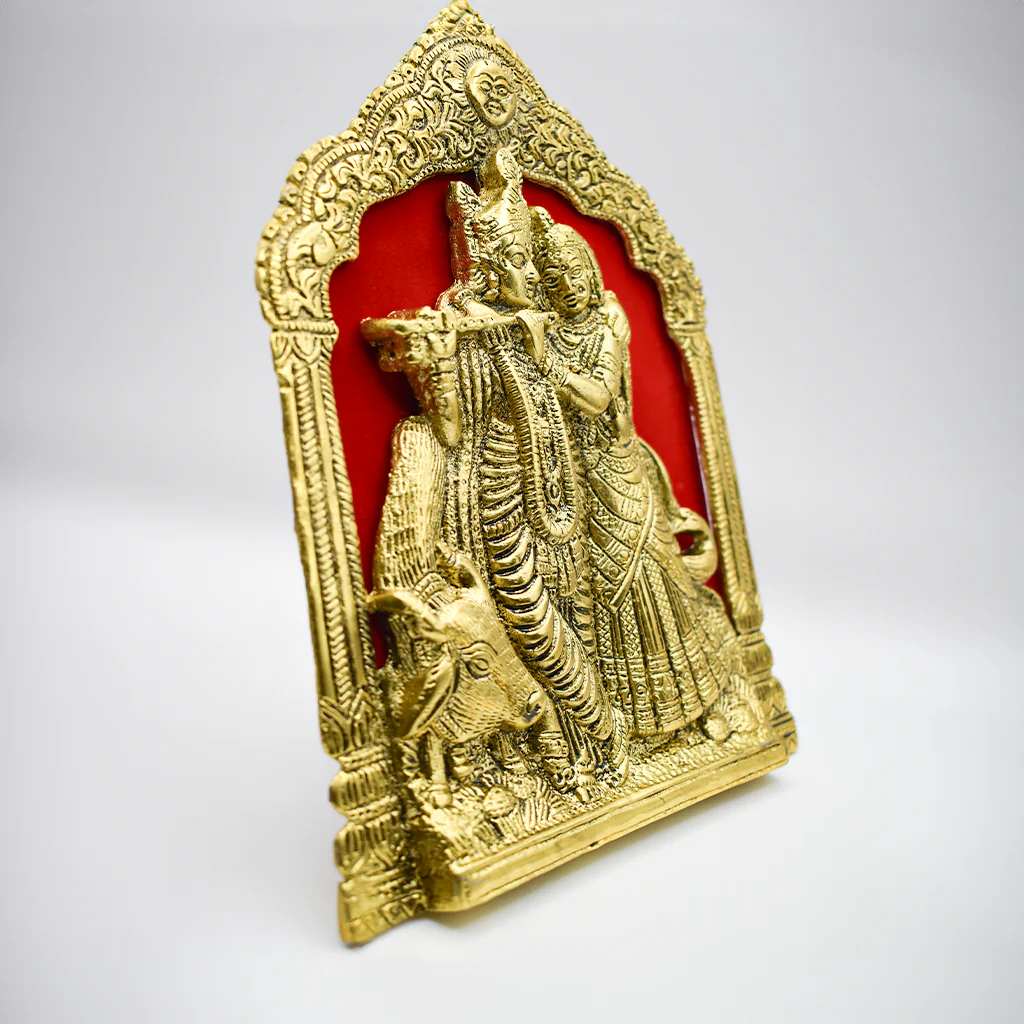 A handcrafted Radha Krishna divine murti (pooja thali) made of aluminum, depicting Radha and Krishna in red and gold hues.