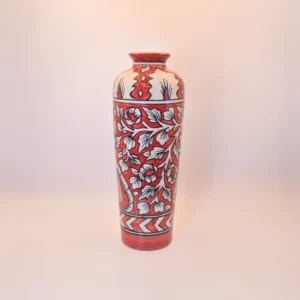 The Crimson Bloom Vase is a true work of art. Its rich red and cream tones, paired with intricate floral patterns, are inspired by timeless traditional Indian designs. Whether placed in a minimalist modern setting or a room filled with vintage décor, this vase stands out beautifully.